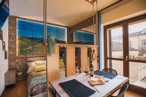 a room with a table and a large window at Appartamento Alba centro storico in Alba