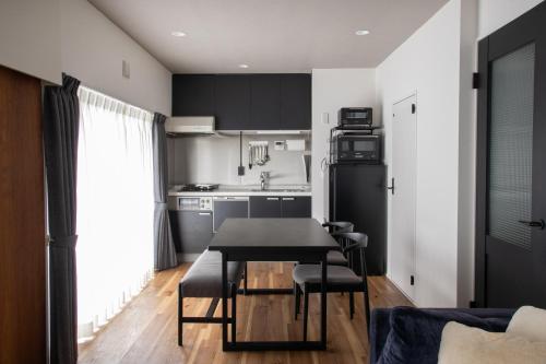 a kitchen and dining room with a table and chairs at NIYS apartments 56type in Tokyo