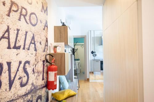 a fire extinguisher is hanging on a wall in a room at Appartamento Alba centro storico in Alba