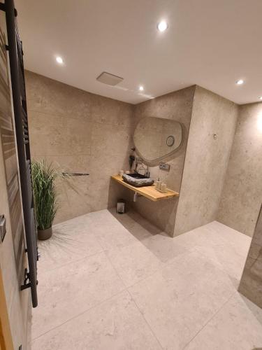 a bathroom with a sink and a mirror at Wellness Chalet Apartment Hochkalter in Bischofswiesen