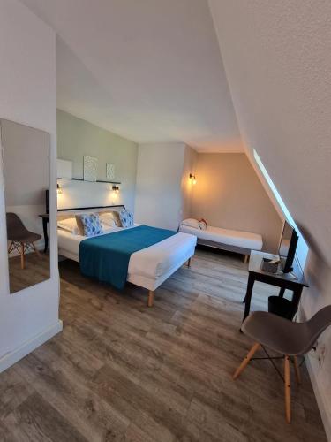 a hotel room with two beds and a chair at Amadour Hôtel in Rocamadour