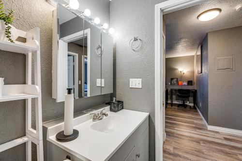 a bathroom with a sink and a mirror at Easily Explore Anchorage! Modern Duplex Near Town in Alaska Regional Hospital Heliport