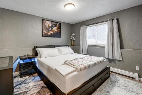 a bedroom with a large bed with a window at Easily Explore Anchorage! Modern Duplex Near Town in Alaska Regional Hospital Heliport