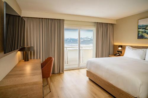 a hotel room with a bed and a large window at DoubleTree by Hilton Wilkes-Barre in Wilkes-Barre