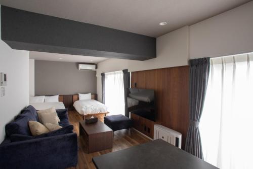 a living room with a couch and a bed at NIYS apartments 56type in Tokyo