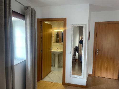 a room with a bathroom with a sink and a mirror at Casa Miná in Montalegre
