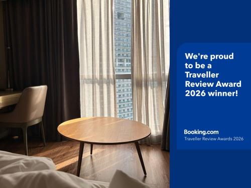 a hotel room with a table and a window at Novotel Suites Celestia at Hotel Residences Manila in Manila
