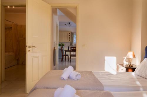 a bedroom with two white pillows on a bed at Villa Olympic Azure with Private Pool in Dassia