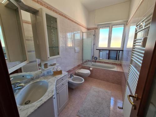 a bathroom with a sink and a toilet and a tub at La Casa di Riki by PortofinoVacanze in Rapallo