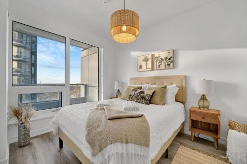 a bedroom with a bed and a large window at Propercare - The Wellingtons in Kitchener