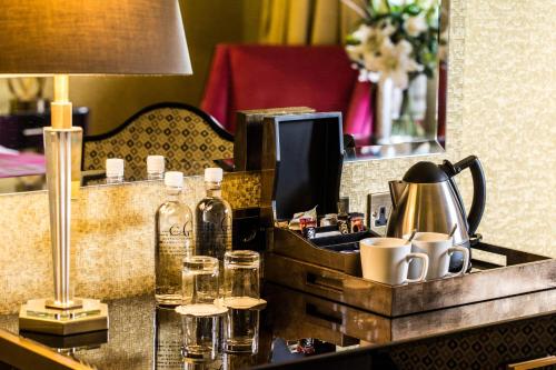 a tray with bottles and cups on a table at Gleddoch Golf & Spa Resort in Langbank
