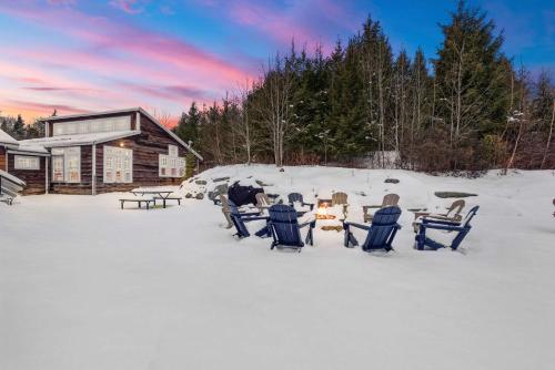 a group of people sitting in chairs in the snow at Myrtle Villa 7BR Near Mount Snow with Indoor Heated Endless Style Pool Outdoor Hot Tub in Dover