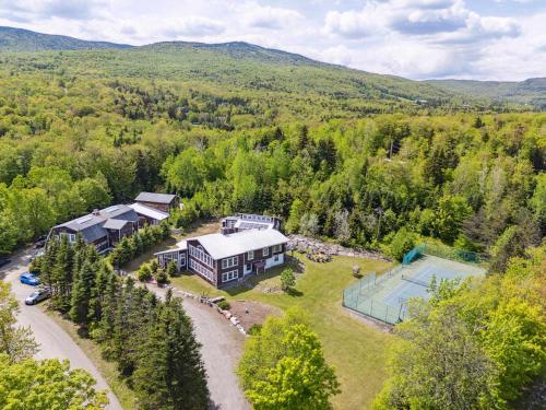 an aerial view of a large house with a pool at Myrtle Villa 7BR Near Mount Snow with Indoor Heated Endless Style Pool Outdoor Hot Tub in Dover