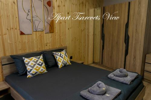 a room with a bed with towels on it at Apart Tsarevets View - Free PARKING in Veliko Tŭrnovo