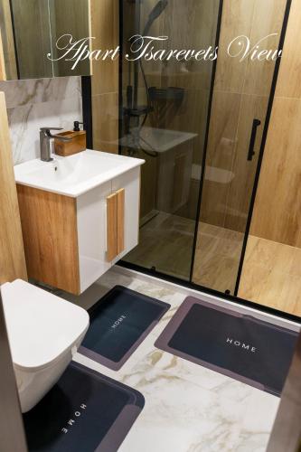 a bathroom with a toilet and a sink and a shower at Apart Tsarevets View - Free PARKING in Veliko Tŭrnovo