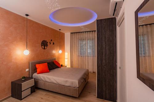 a bedroom with a bed with a blue ceiling at Harmony House in Castellana Grotte