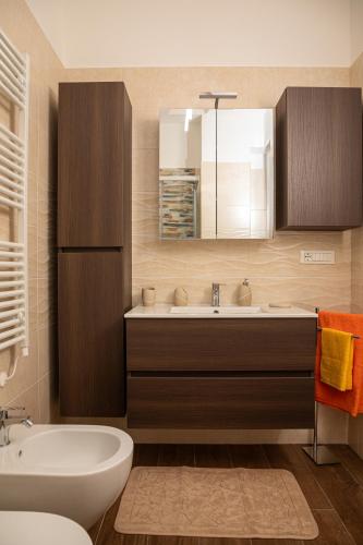 a bathroom with a sink and a tub and a mirror at Harmony House in Castellana Grotte