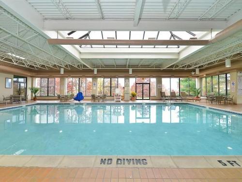 a swimming pool with a no swimming sign in a building at DoubleTree by Hilton Wilkes-Barre in Wilkes-Barre