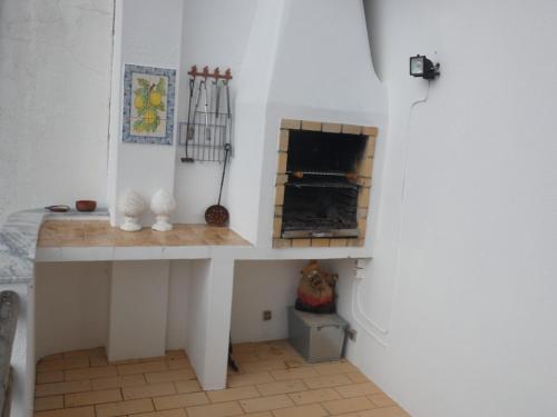 a room with a table with a fireplace in it at Casa Caracol in Praia do Carvoeiro