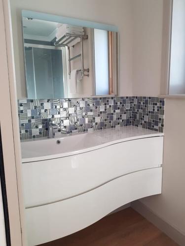 a bathroom with a mirror and a bath tub at Anchors Aweigh in Stanley