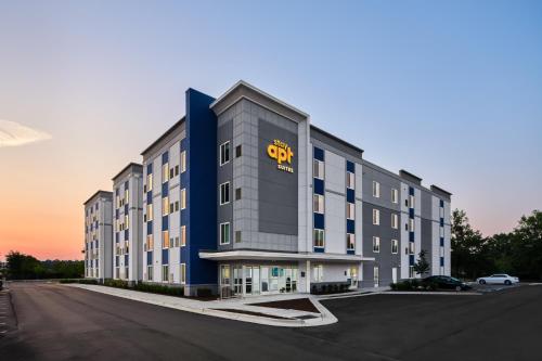 a large building with a gold sign on it at stayAPT Suites Fayetteville-Fort Bragg in Fayetteville
