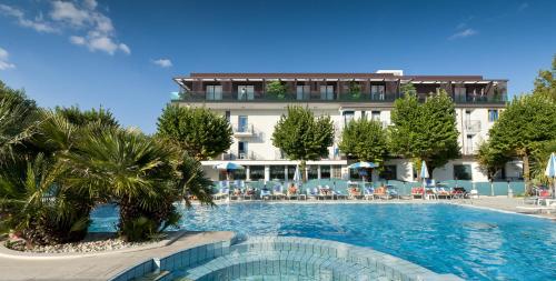 a large swimming pool in front of a hotel at Suite Apartment Exclusive in Bellaria-Igea Marina