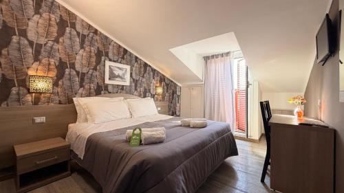 a bedroom with a bed with two towels on it at Hotel Concorde in Rome