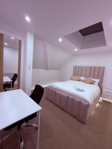 a bedroom with a bed and a desk and a table at Premium Apartment with Dover Castle Views, Central Dover in Dover