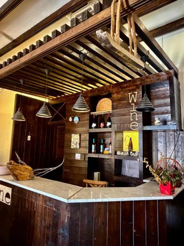a bar in a restaurant with pendant lights at Art House Mestia in Mestia