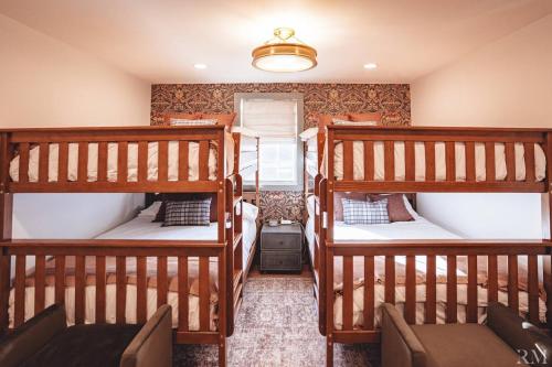 a room with three bunk beds in it at Sunset Cottage Hocking Hills in Rockbridge