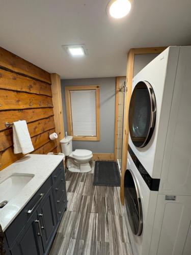 a bathroom with a sink and a washing machine at The Treehouse at 11 Gables - Center of Ludlow Village near Shopping and Restaurants in Ludlow