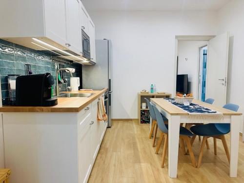 a kitchen with a table and chairs and a kitchen with a counter top at Casa Genzino in Molfetta