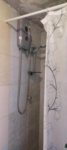 a shower curtain with a flower pattern on it in a bathroom at Casa de Juanita in Cajamarca