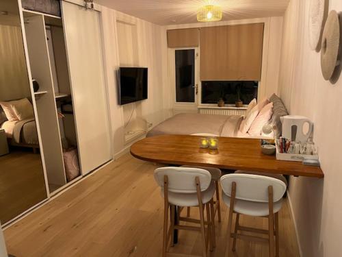 a living room with a table and chairs and a bed at Quarles 80 - free parking in Noordwijk aan Zee