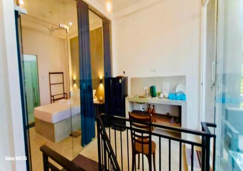 a room with a bathroom with a bed and a balcony at Villa Jesmin Home - Sea View in Habaraduwa Central