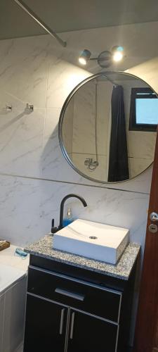 a bathroom with a sink and a mirror at ARWEN Suites 1 in Trevelín