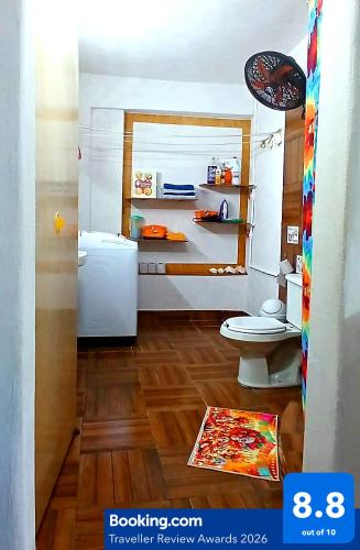 a bathroom with a white refrigerator and a toilet at Casa Del Chef Lupita in Campeche