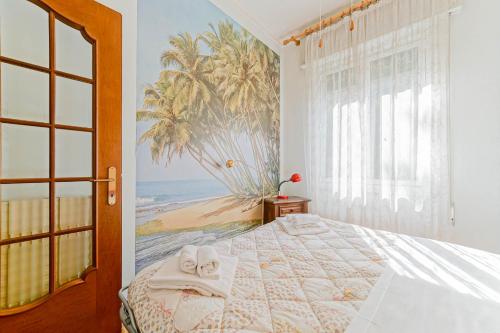 a bedroom with a bed with a mural of a beach at Casa Patrizia by PortofinoVacanze in Rapallo