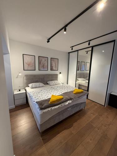 a bedroom with a large bed with yellow pillows on it at Residence Stina in Široki Brijeg