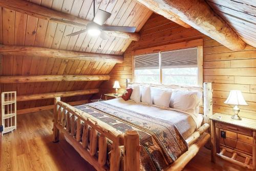 a bedroom with a bed in a log cabin at Wooded Family Retreat! 11 Mi to Acadia Entrance in Trenton
