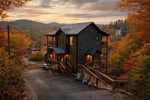 a house in the middle of a forest in the fall at Big Bear Shack - Handicap Accessible & Dog Friendly in Gatlinburg