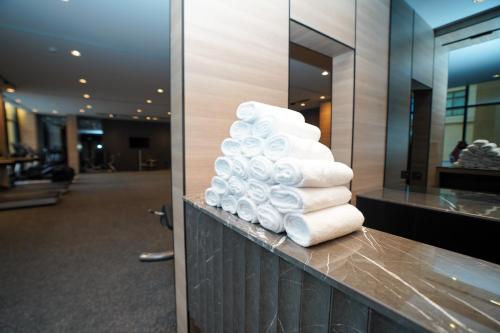 a stack of towels on a counter in a hotel room at Azha Alriyadh in Riyadh