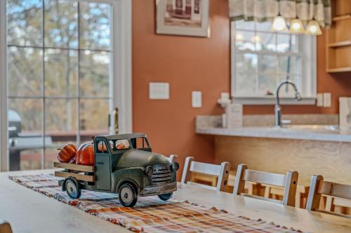 a toy truck sitting on top of a table at Creekview Cabin - Hot Tub, EV Station, Pet Friendly, Screen Porch, Wifi, Grill, Fire Pit, Deck, Family Friendly, Game Room, King Bed in Morton Grove