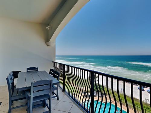 a balcony with a table and chairs and the ocean at Adagio #403B in Santa Rosa Beach