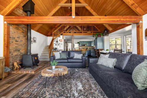 a living room with a couch and a fireplace at Cozy Chalet in the Pines in Munds Park
