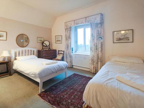 a bedroom with two beds and a window at 4 Bed in Lower Bockhampton oc-t34129 in West Stafford