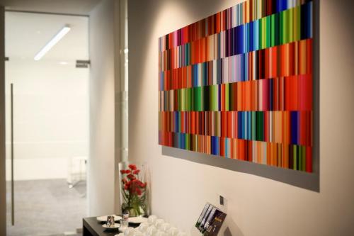 a colorful painting hanging on a wall in a room at Hotel Schempp in Bobingen