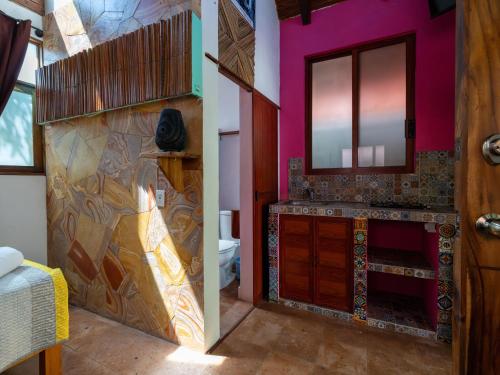 a bathroom with a sink and a mirror at Las Barracas de la Barra in Malucano