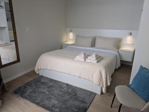 a bedroom with a bed with two towels on it at Monte Gordo Accommodation in Ribeira Brava
