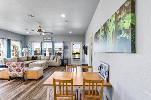 a living room with a table and chairs at Steps to the Beach l Modern Interior in Crystal Beach